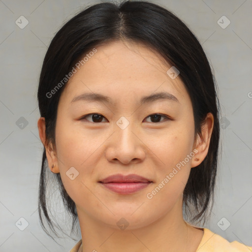 Joyful asian young-adult female with medium  brown hair and brown eyes