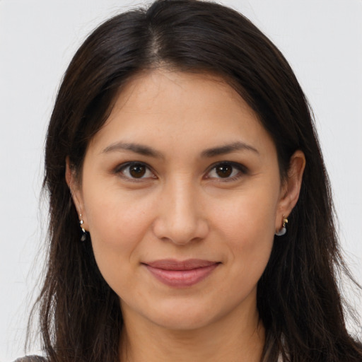 Joyful latino young-adult female with long  brown hair and brown eyes