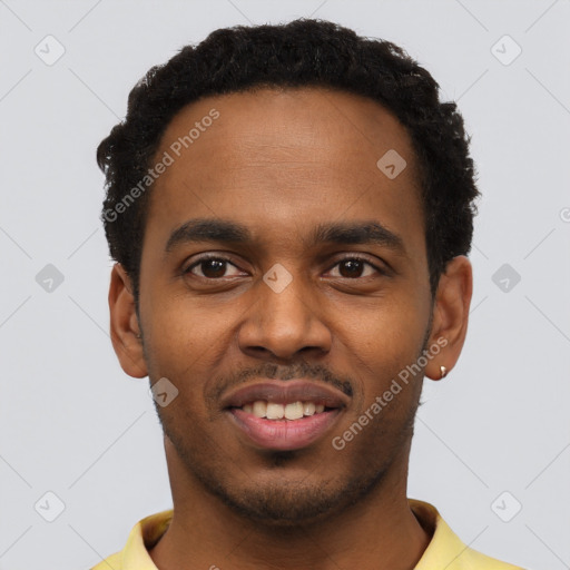 Joyful black young-adult male with short  black hair and brown eyes