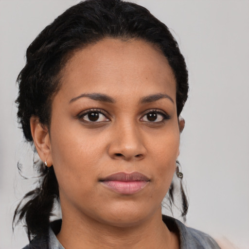 Joyful latino young-adult female with medium  black hair and brown eyes