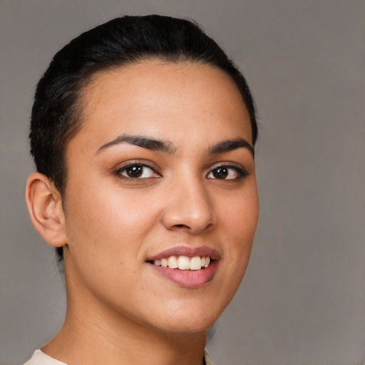 Joyful latino young-adult female with short  brown hair and brown eyes