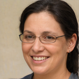 Joyful white adult female with medium  brown hair and brown eyes