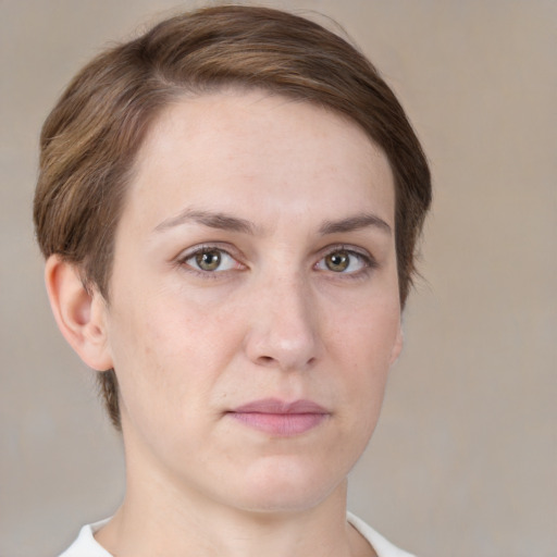 Joyful white young-adult female with short  brown hair and grey eyes