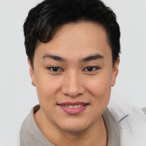 Joyful asian young-adult female with short  black hair and brown eyes