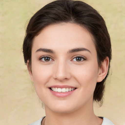 Joyful white young-adult female with medium  brown hair and brown eyes