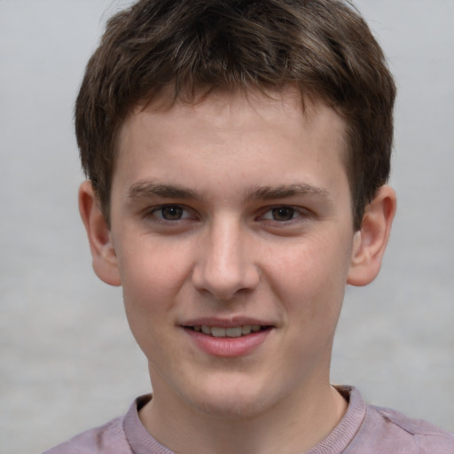 Joyful white child male with short  brown hair and grey eyes