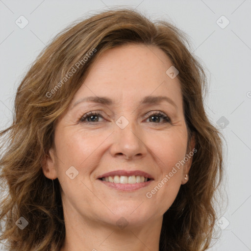 Joyful white adult female with long  brown hair and brown eyes