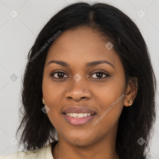 Joyful black young-adult female with long  brown hair and brown eyes