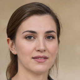 Joyful white young-adult female with medium  brown hair and brown eyes