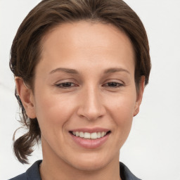 Joyful white young-adult female with short  brown hair and grey eyes