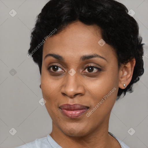 Joyful black young-adult female with short  black hair and brown eyes