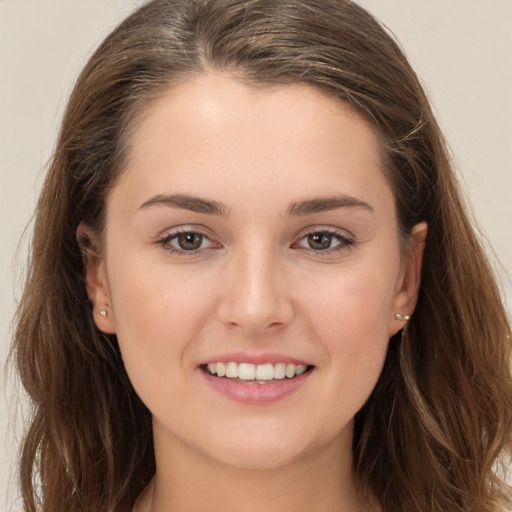 Joyful white young-adult female with long  brown hair and brown eyes