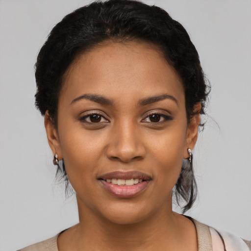Joyful latino young-adult female with short  black hair and brown eyes