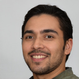 Joyful white young-adult male with short  black hair and brown eyes