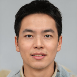 Joyful asian young-adult male with short  black hair and brown eyes