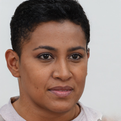 Joyful black young-adult female with short  brown hair and brown eyes