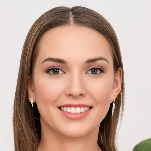 Joyful white young-adult female with long  brown hair and green eyes