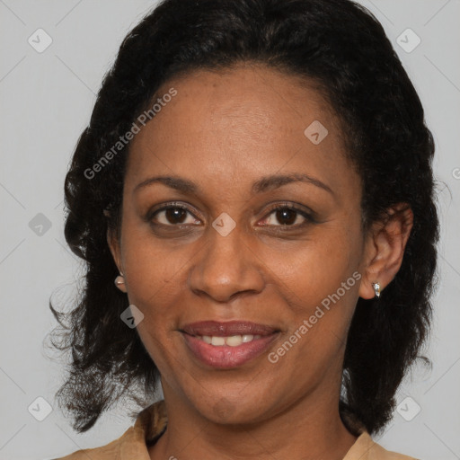 Joyful black adult female with medium  brown hair and brown eyes