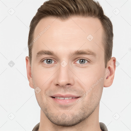 Joyful white young-adult male with short  brown hair and grey eyes