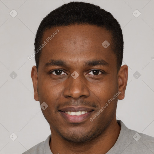 Joyful black young-adult male with short  brown hair and brown eyes