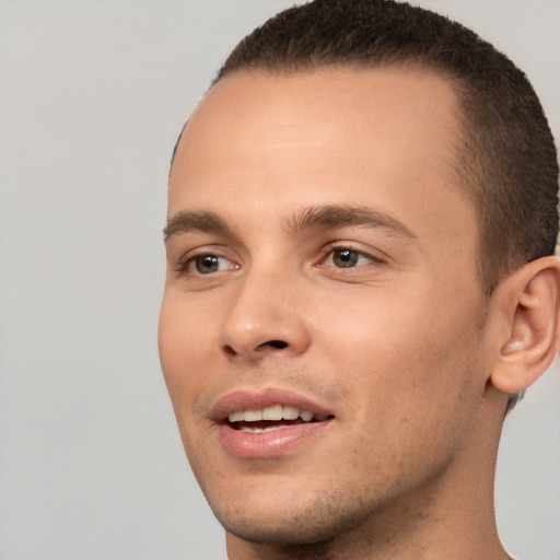 Joyful white young-adult male with short  brown hair and brown eyes