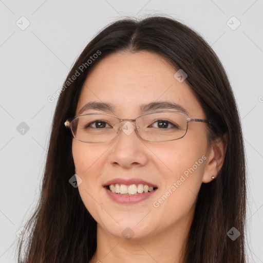 Joyful white adult female with long  brown hair and brown eyes