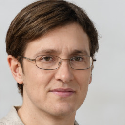 Joyful white adult male with short  brown hair and grey eyes