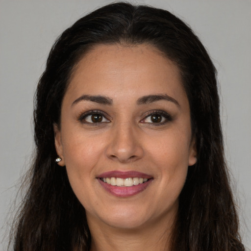 Joyful white young-adult female with long  brown hair and brown eyes