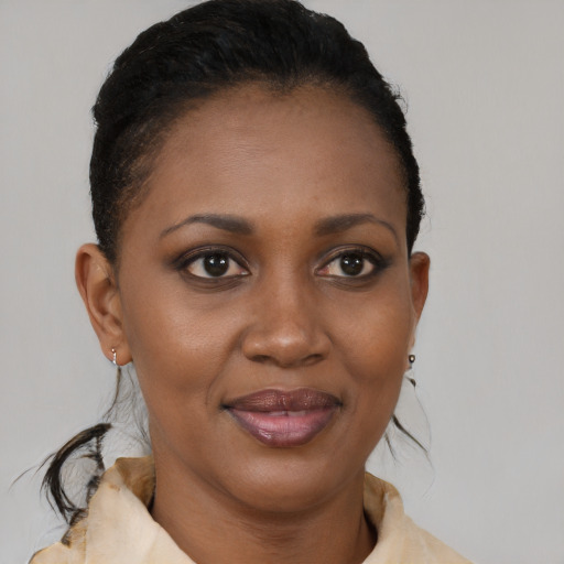 Joyful black young-adult female with medium  brown hair and brown eyes