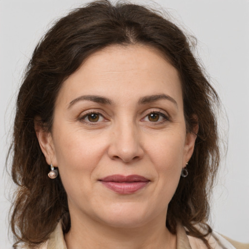 Joyful white adult female with medium  brown hair and grey eyes