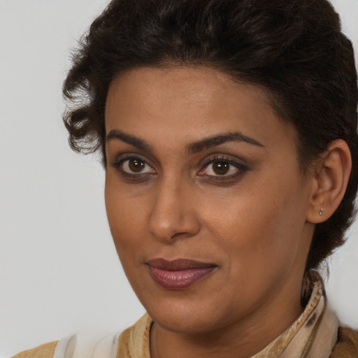 Joyful black young-adult female with medium  brown hair and brown eyes