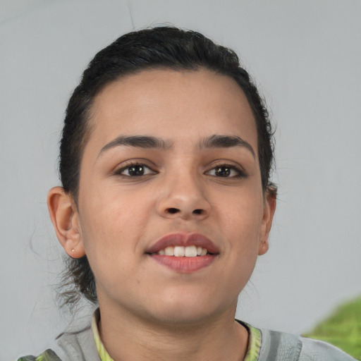 Joyful latino young-adult female with short  brown hair and brown eyes