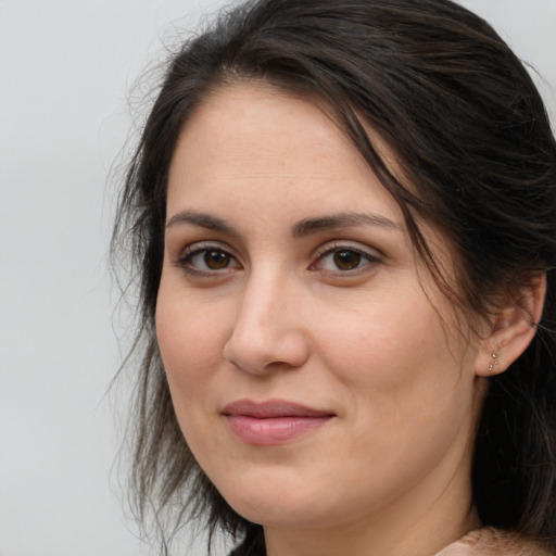 Joyful white adult female with long  brown hair and brown eyes