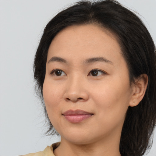Joyful asian adult female with medium  brown hair and brown eyes