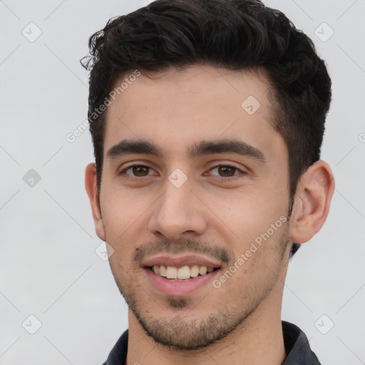 Joyful white young-adult male with short  black hair and brown eyes