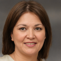 Joyful white adult female with medium  brown hair and brown eyes