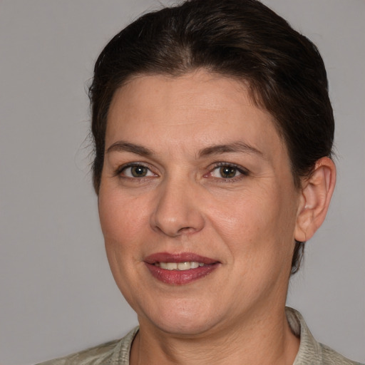 Joyful white adult female with medium  brown hair and brown eyes