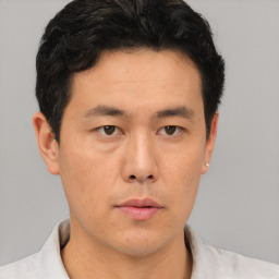 Neutral asian young-adult male with short  brown hair and brown eyes