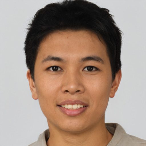 Joyful asian young-adult male with short  brown hair and brown eyes