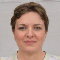 Joyful white young-adult female with short  brown hair and grey eyes