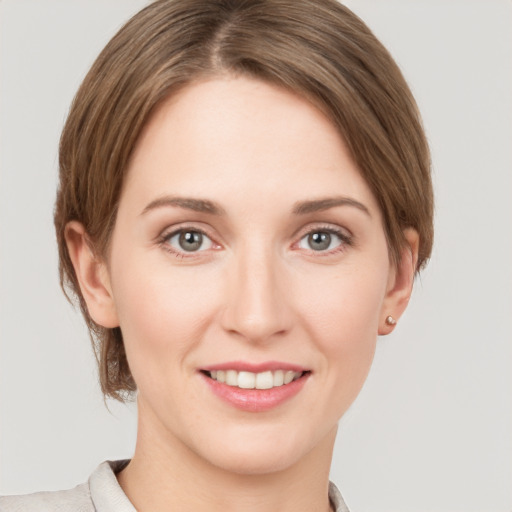 Joyful white young-adult female with short  brown hair and grey eyes