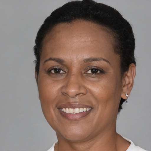 Joyful black adult female with short  brown hair and brown eyes