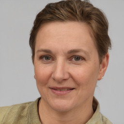 Joyful white adult female with short  brown hair and grey eyes