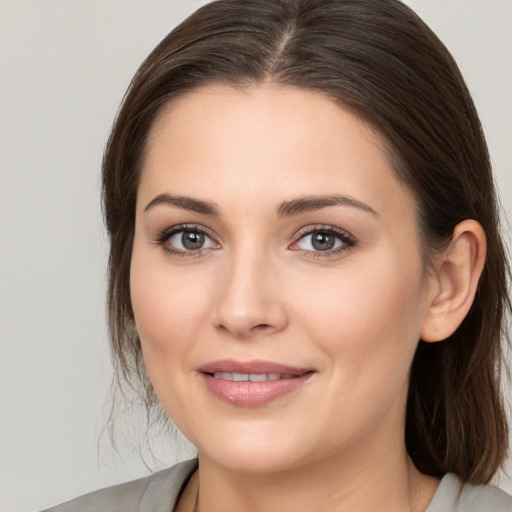 Joyful white young-adult female with medium  brown hair and brown eyes