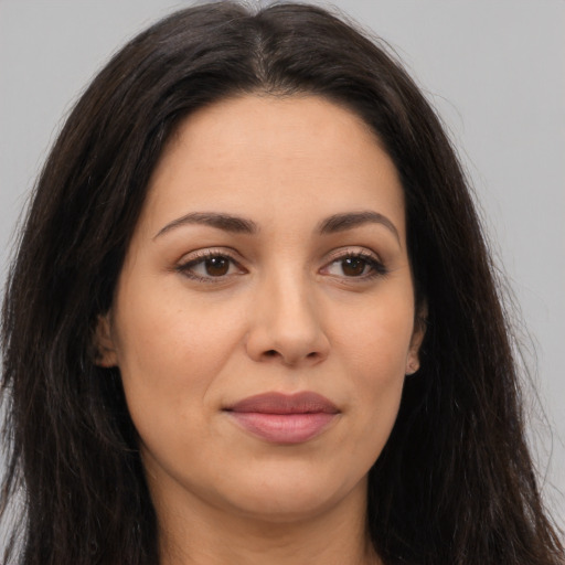 Joyful latino young-adult female with long  brown hair and brown eyes