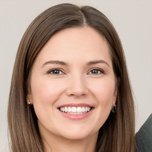 Joyful white young-adult female with long  brown hair and brown eyes