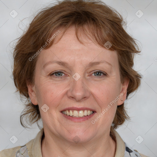 Joyful white adult female with medium  brown hair and blue eyes