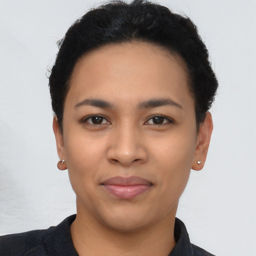 Joyful latino young-adult female with short  black hair and brown eyes