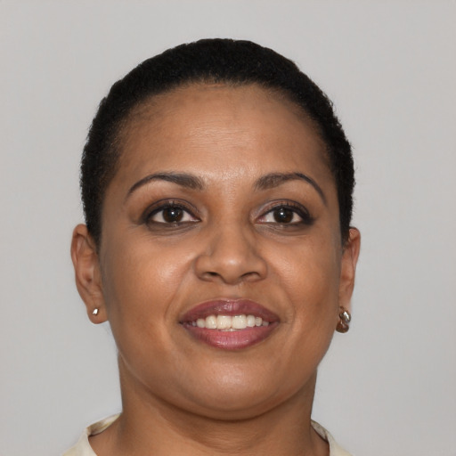 Joyful black young-adult female with short  brown hair and brown eyes