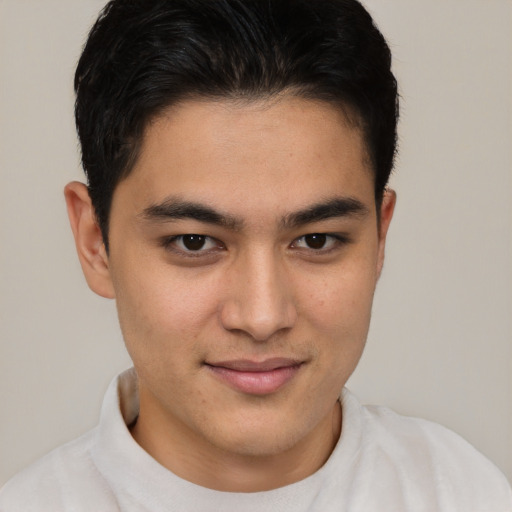 Joyful latino young-adult male with short  brown hair and brown eyes